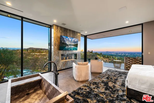 a view of a patio with table and chairs and potted plants