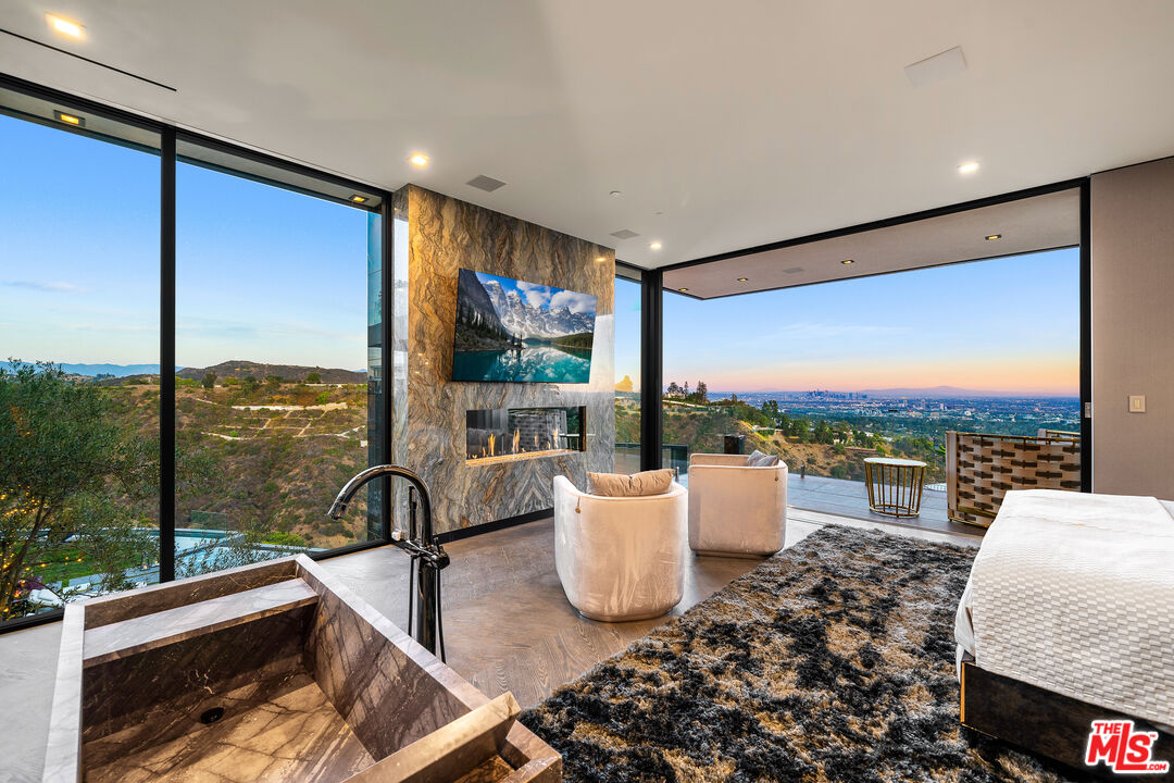 1200 Bel Air Road Los Angeles, CA 90077 - Photo 20 of 27 a living room with patio furniture and a floor to ceiling window