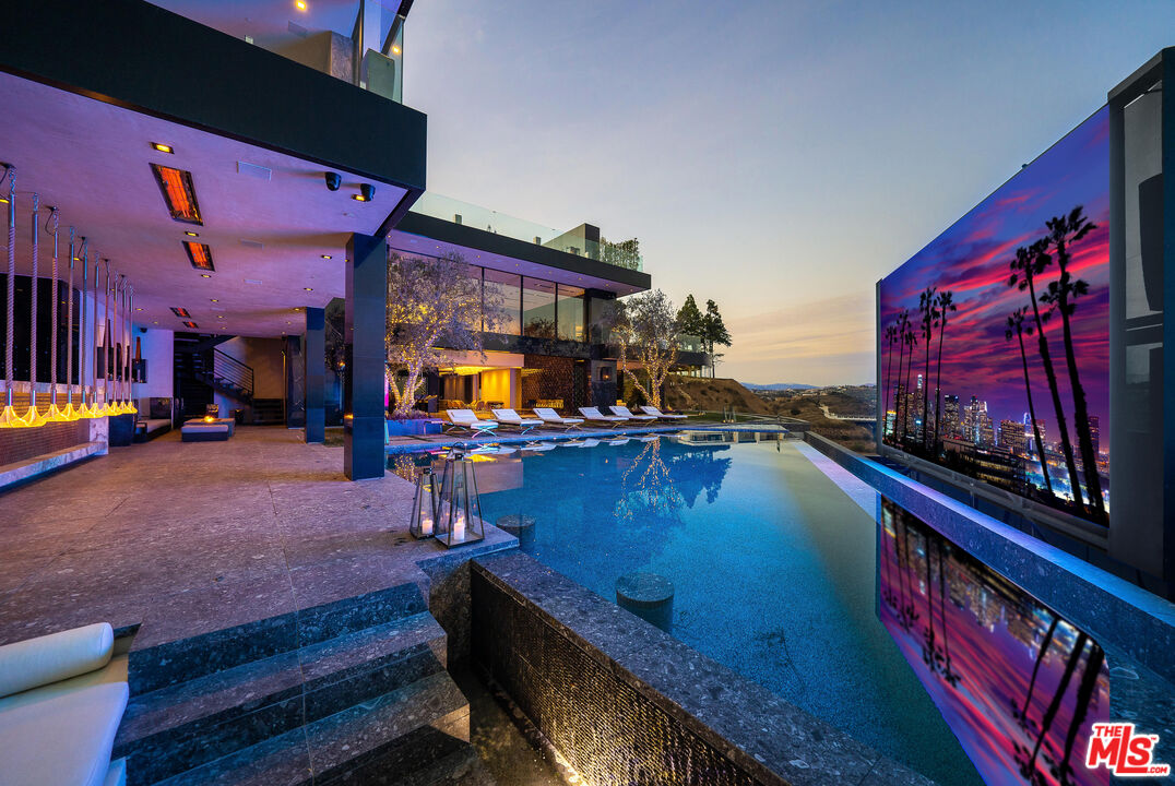 1200 Bel Air Road Los Angeles, CA 90077 - Photo 2 of 27 a room with lots of furniture and clutter