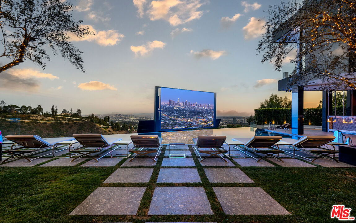 1200 Bel Air Road Los Angeles, CA 90077 - Photo 22 of 27 a backyard of a house with table and chairs