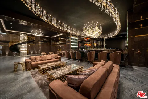 a view of a dining room with furniture and a chandelier