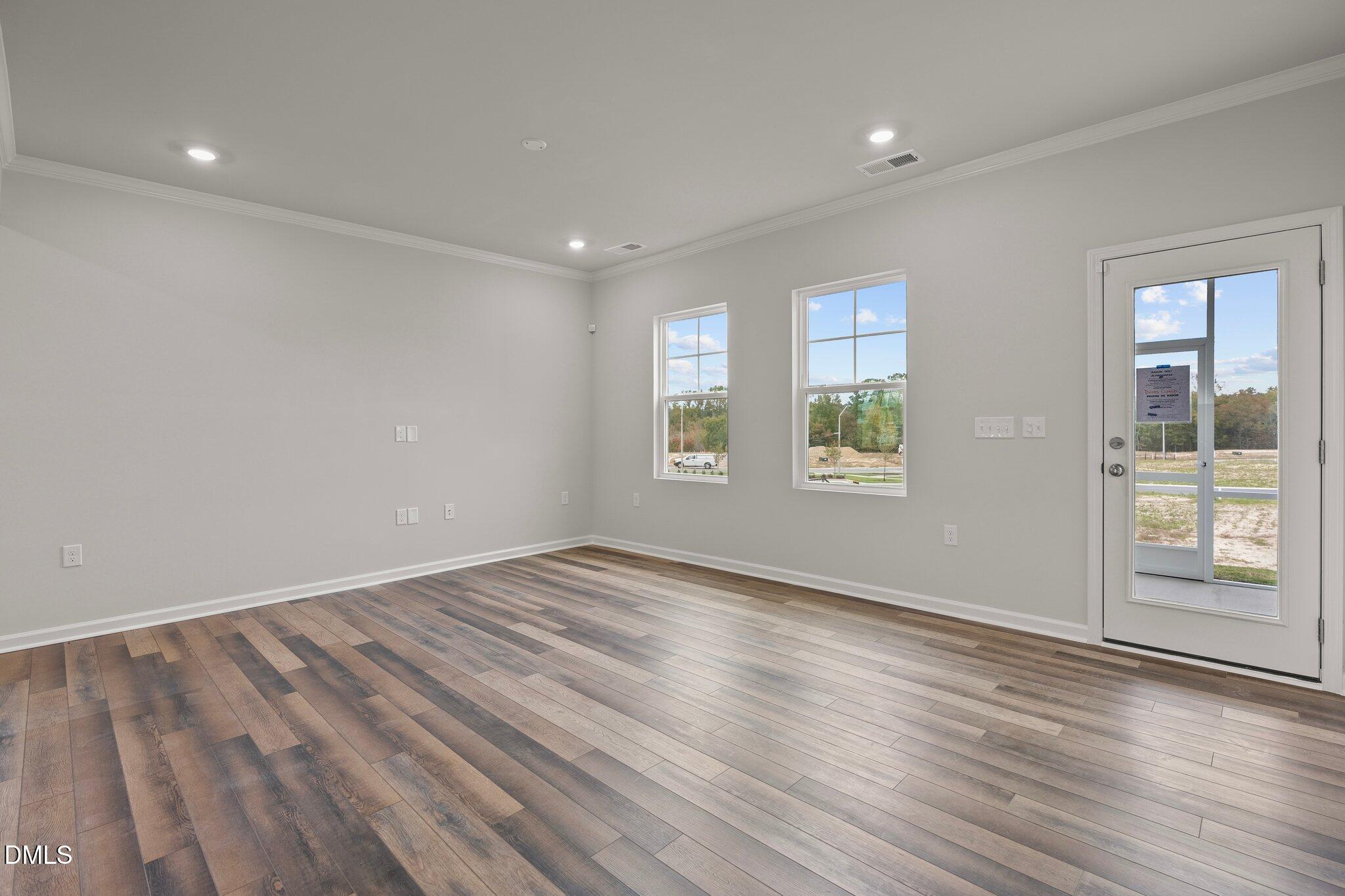 5031 Kota Street Raleigh, NC 27610 - Photo 11 of 84 a view of an empty room with wooden floor and a window