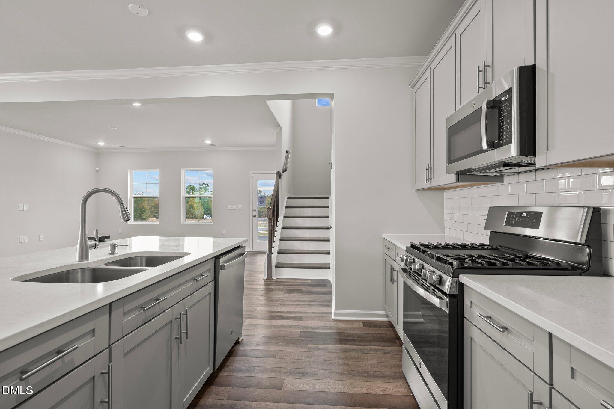 5031 Kota Street Raleigh, NC 27610 - Photo 13 of 84 a kitchen with stainless steel appliances granite countertop a sink and stove top oven