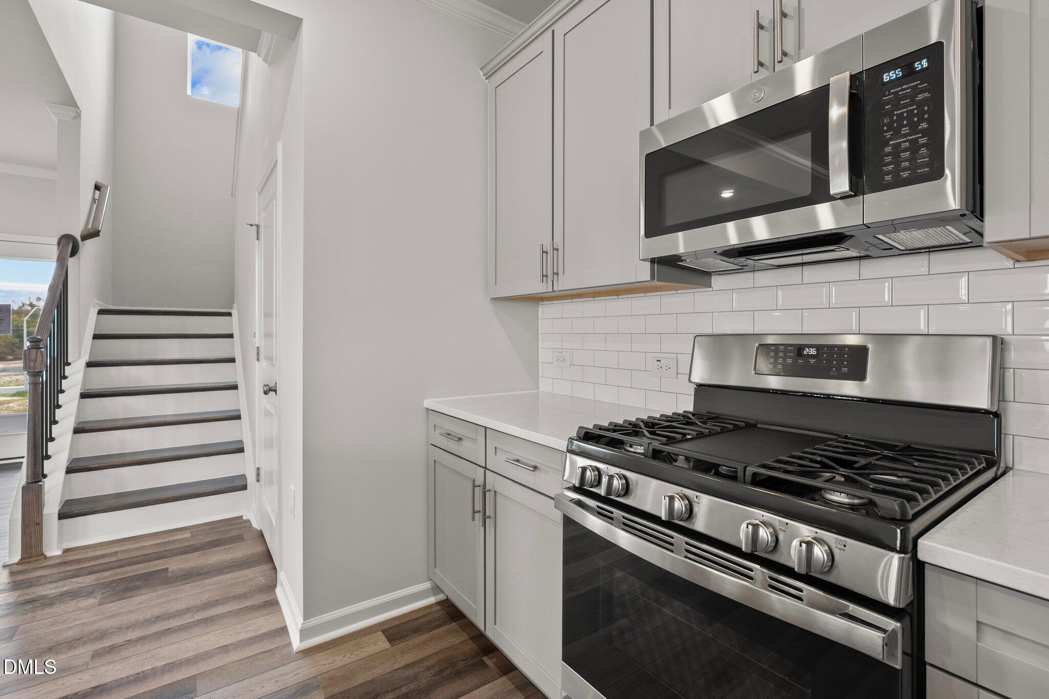 5031 Kota Street Raleigh, NC 27610 - Photo 17 of 84 a kitchen with stainless steel appliances granite countertop a stove and a microwave