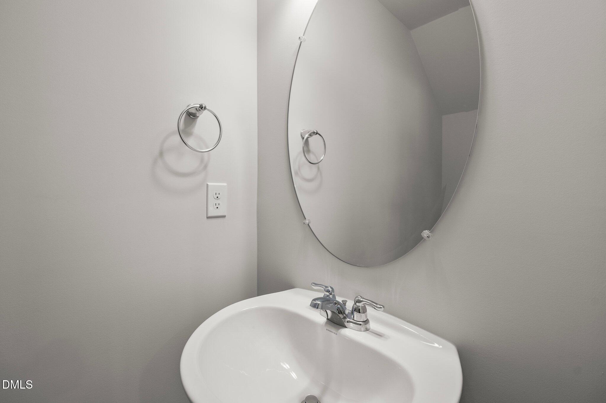 5031 Kota Street Raleigh, NC 27610 - Photo 23 of 84 a bathroom with a sink and mirror