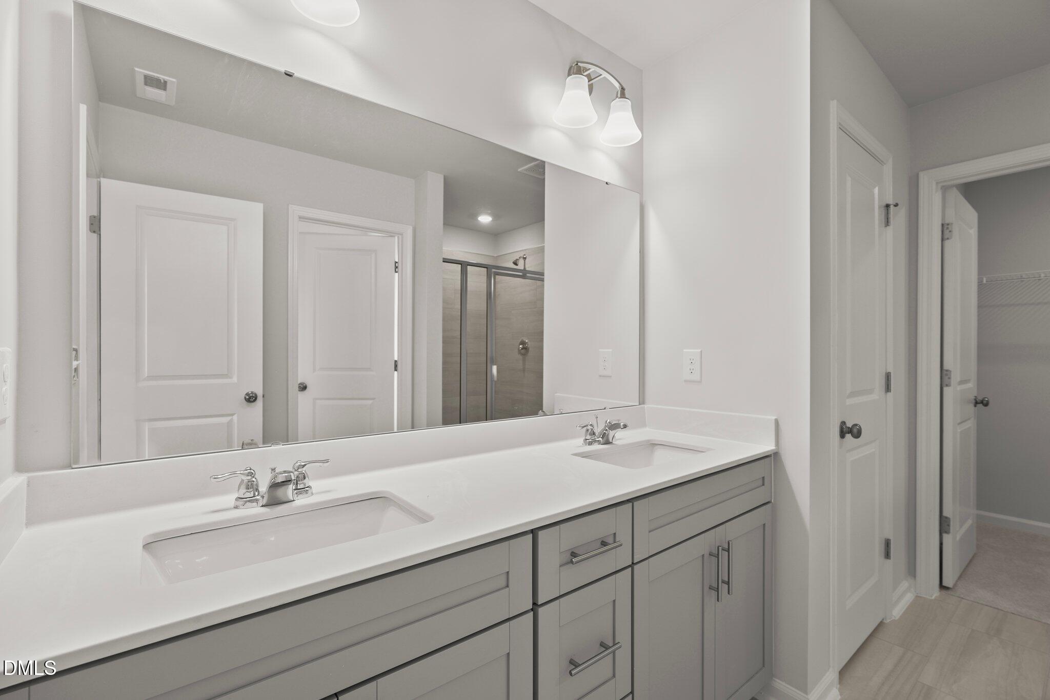 5031 Kota Street Raleigh, NC 27610 - Photo 32 of 84 a bathroom with a sink and a mirror