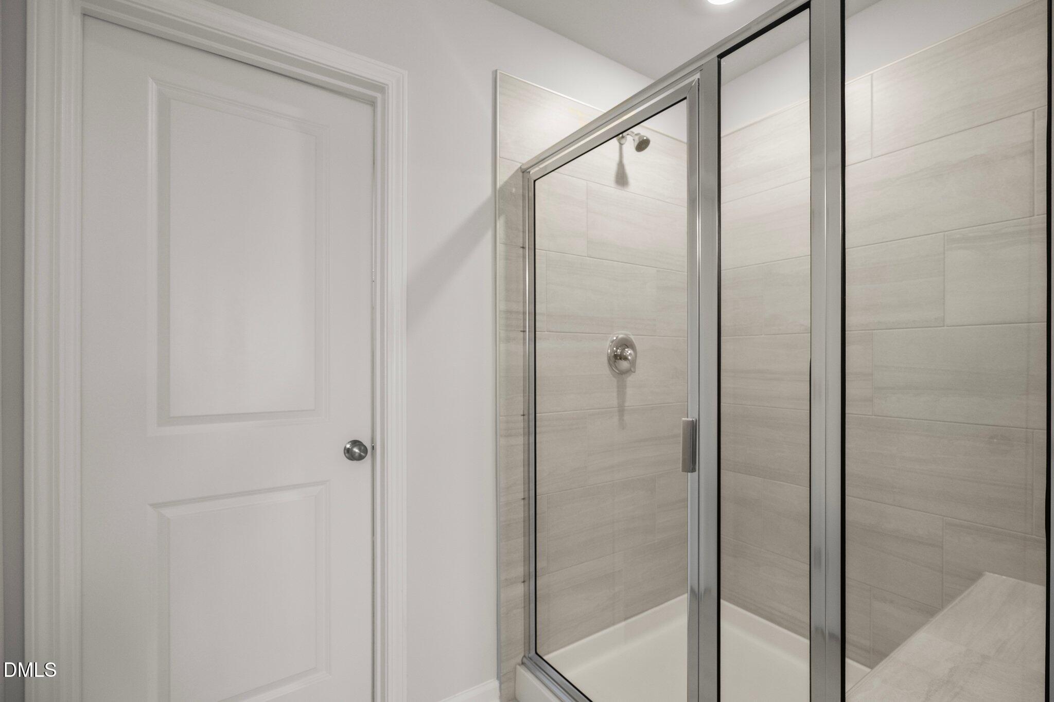 5031 Kota Street Raleigh, NC 27610 - Photo 35 of 84 a bathroom with a glass shower door