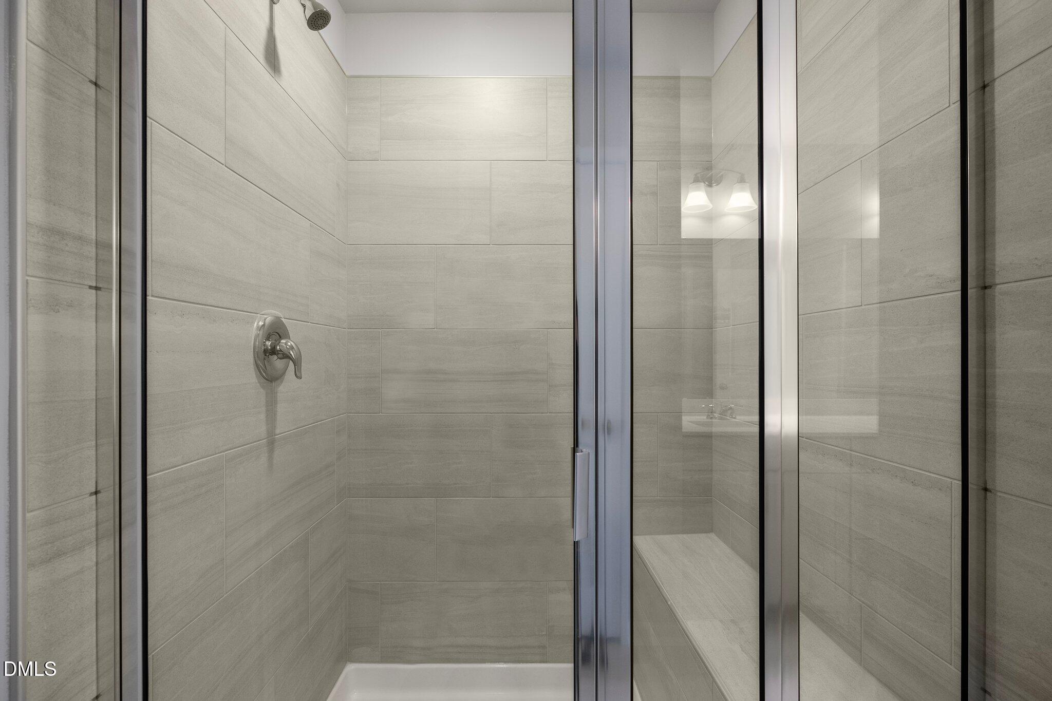 5031 Kota Street Raleigh, NC 27610 - Photo 36 of 84 a bathroom with a glass shower door