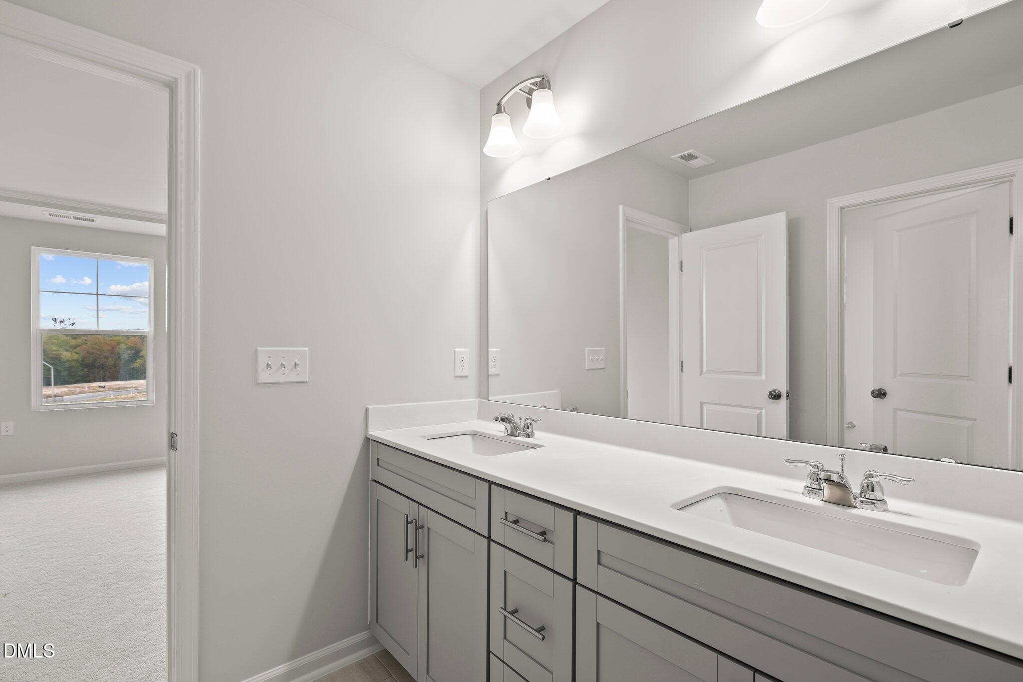 5031 Kota Street Raleigh, NC 27610 - Photo 37 of 84 a bathroom with a sink and a mirror