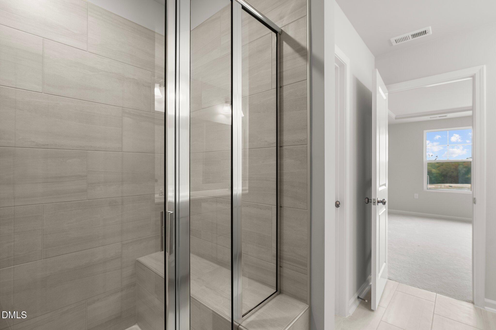 5031 Kota Street Raleigh, NC 27610 - Photo 39 of 84 a bathroom with a glass shower door