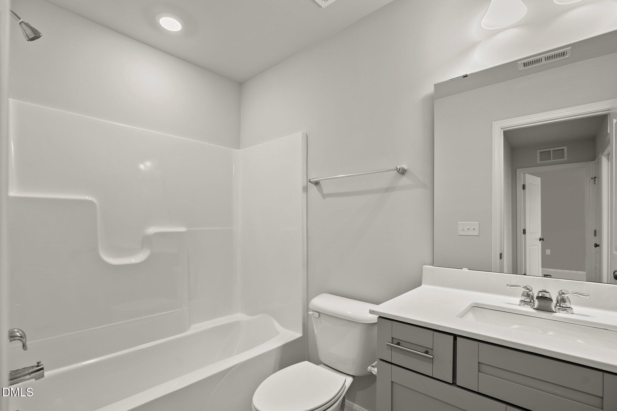 5031 Kota Street Raleigh, NC 27610 - Photo 43 of 84 a bathroom with a granite countertop sink toilet and shower