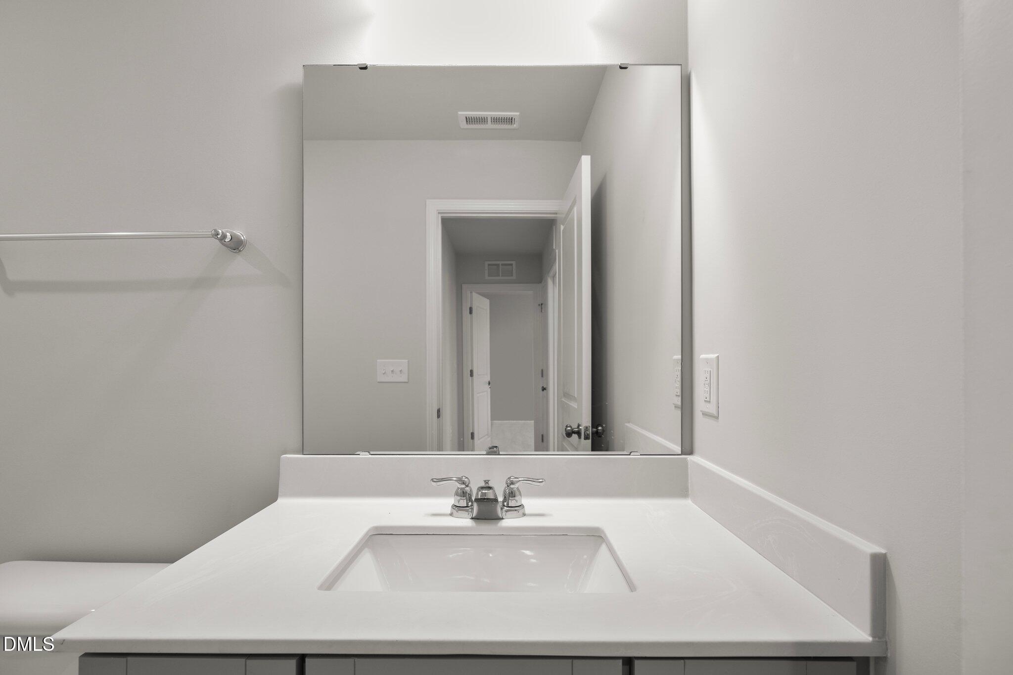 5031 Kota Street Raleigh, NC 27610 - Photo 44 of 84 a bathroom with a sink and a mirror