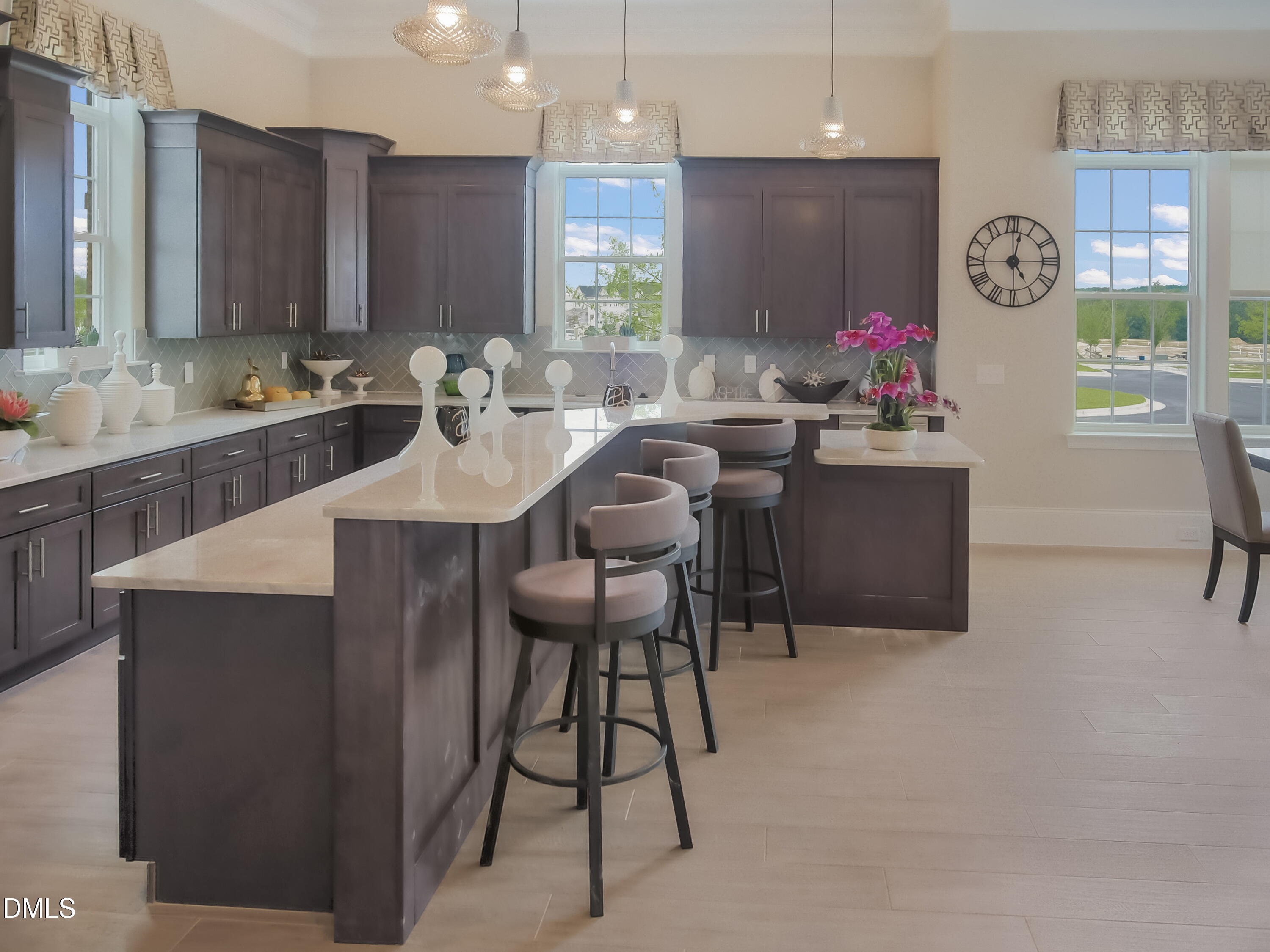 5031 Kota Street Raleigh, NC 27610 - Photo 56 of 84 a kitchen with stainless steel appliances kitchen island granite countertop a table chairs in it and wooden floors