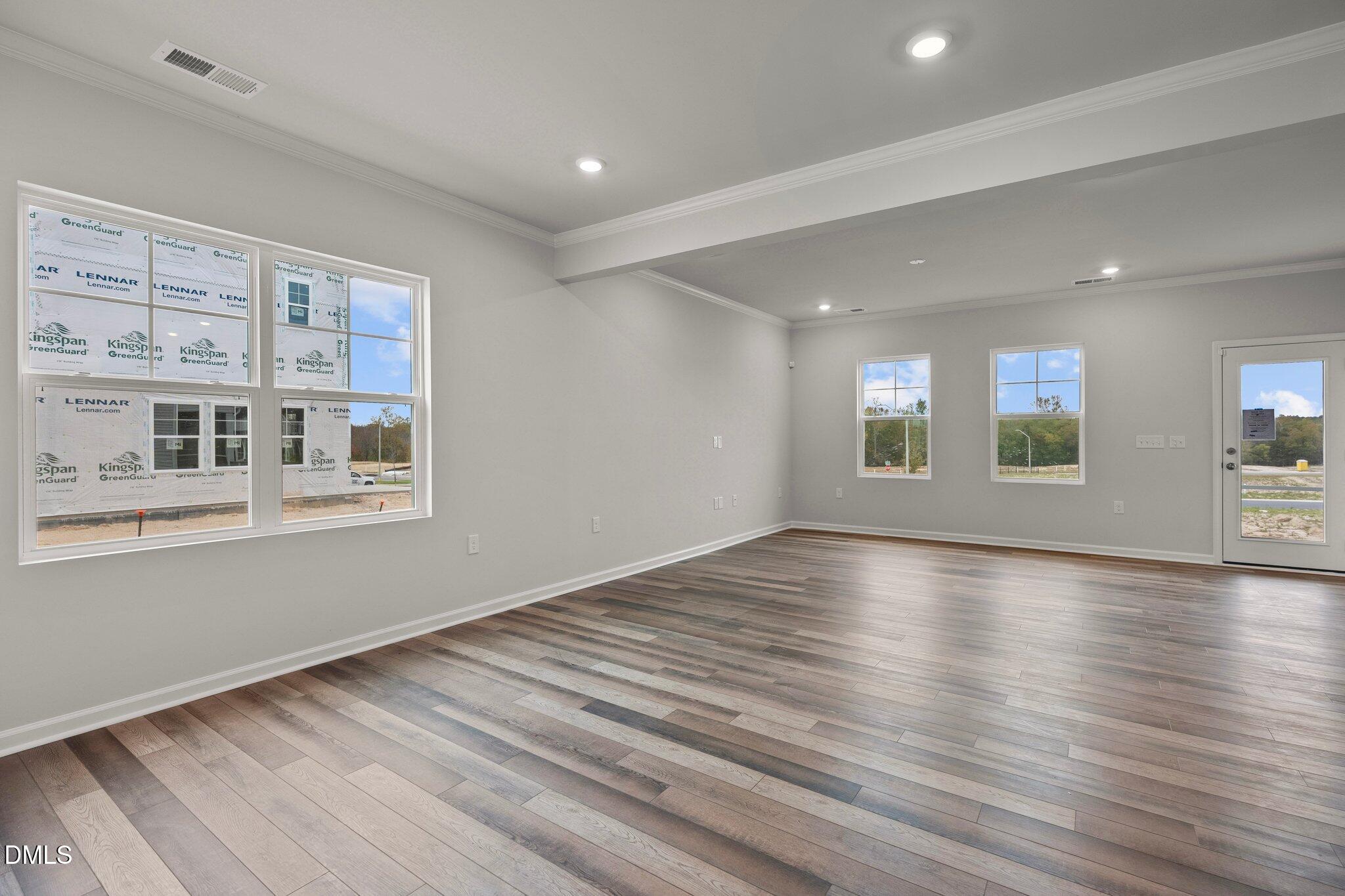 5031 Kota Street Raleigh, NC 27610 - Photo 7 of 84 a view of an empty room with wooden floor and a window