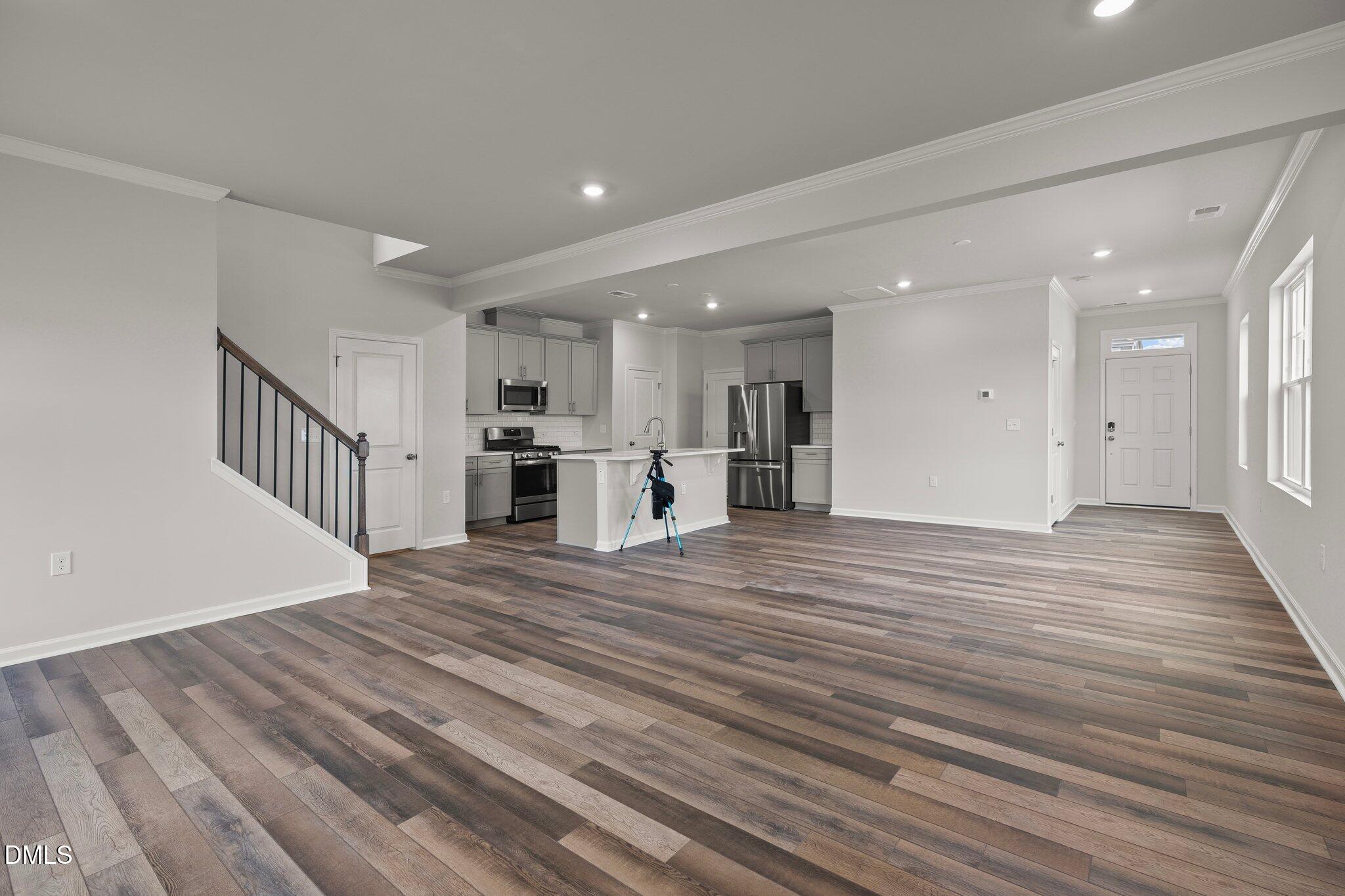 5031 Kota Street Raleigh, NC 27610 - Photo 9 of 84 a view of a room with wooden floor and a kitchen