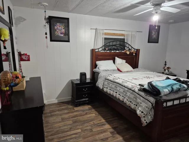 a bedroom with a bed and a lamp on dresser