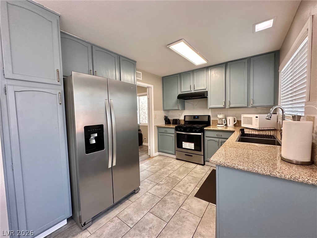 2340 Viewcrest Road Henderson, NV 89014 - Photo 15 of 36 This bright kitchen features durable tile flooring, ample cabinetry, and sleek stainless steel appliances.