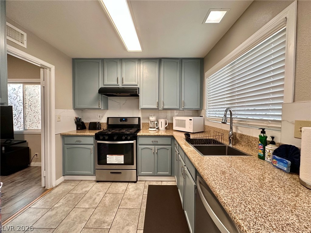 2340 Viewcrest Road Henderson, NV 89014 - Photo 16 of 36 This kitchen offers practical design, featuring efficient appliances and a bright window.