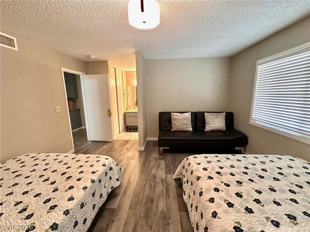 2340 Viewcrest Road Henderson, NV 89014 - Photo 18 of 36 This versatile space features durable flooring and a window with blinds, offering adaptable living arrangements.