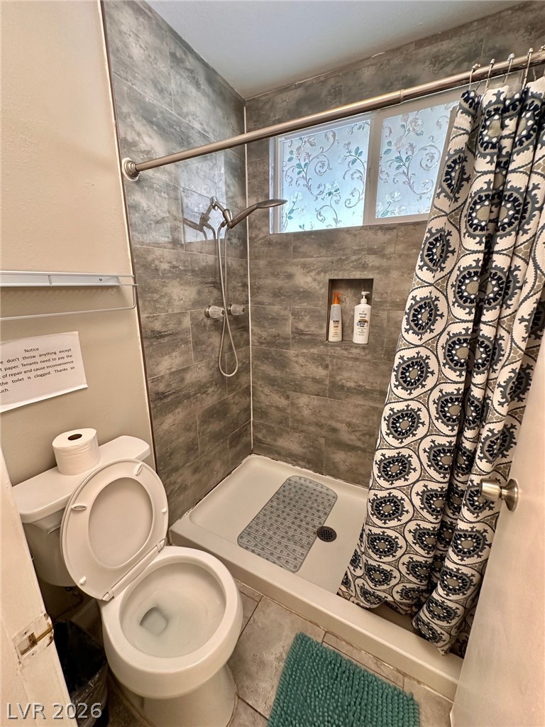 2340 Viewcrest Road Henderson, NV 89014 - Photo 20 of 36 This clean and functional bathroom features a shower with tiled walls and a window.