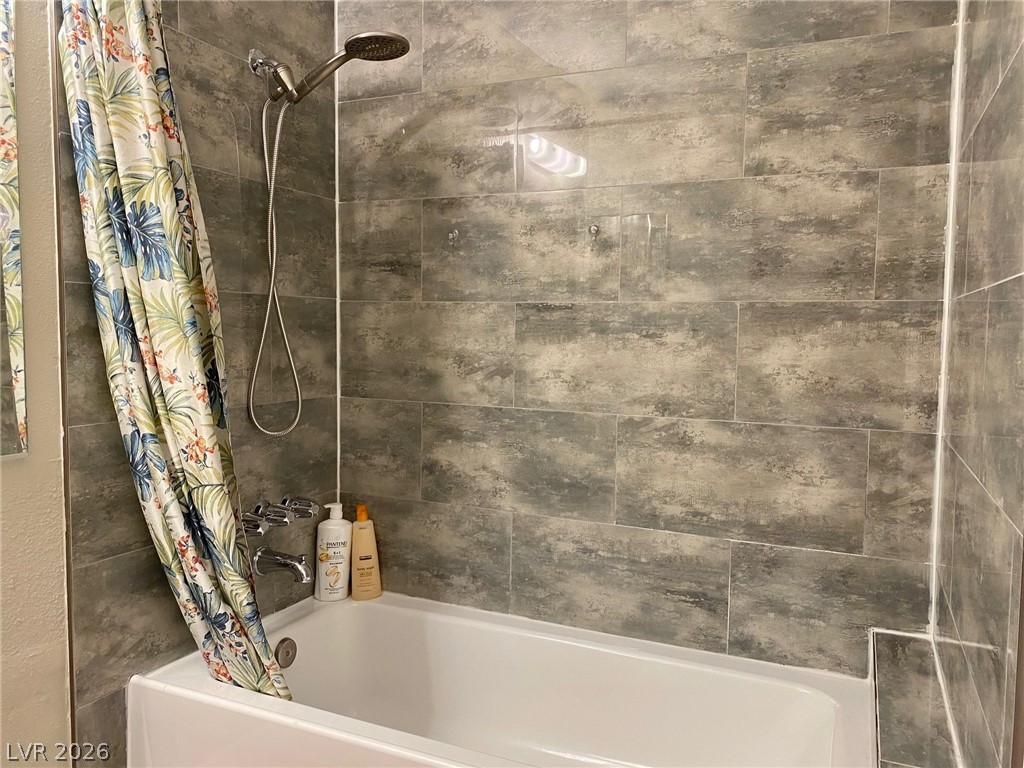 2340 Viewcrest Road Henderson, NV 89014 - Photo 24 of 36 This clean bathroom features modern tile work and a convenient shower-over-tub design.