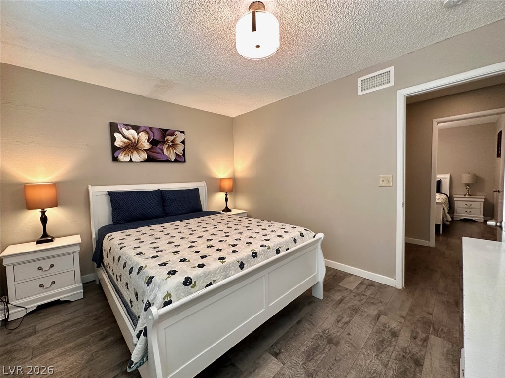 2340 Viewcrest Road Henderson, NV 89014 - Photo 25 of 36 This cozy bedroom offers comfort and a tranquil escape.