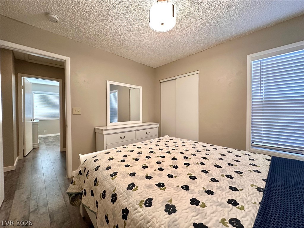 2340 Viewcrest Road Henderson, NV 89014 - Photo 29 of 36 This cozy bedroom features durable wood flooring and ample natural light through its window.