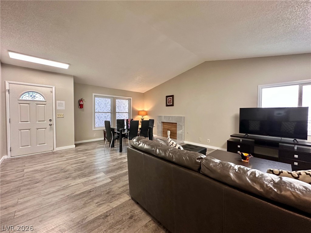 2340 Viewcrest Road Henderson, NV 89014 - Photo 8 of 36 This inviting space features an elegant fireplace and durable flooring, perfect for comfortable living.