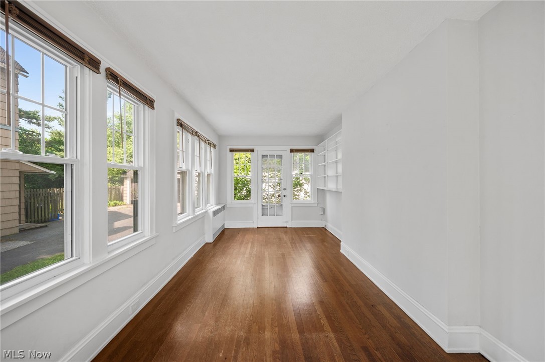 2924 Brighton Road Shaker Heights, OH 44120 - Photo 14 of 31 Unfurnished sunroom featuring wood finished floors, baseboards, and french doors