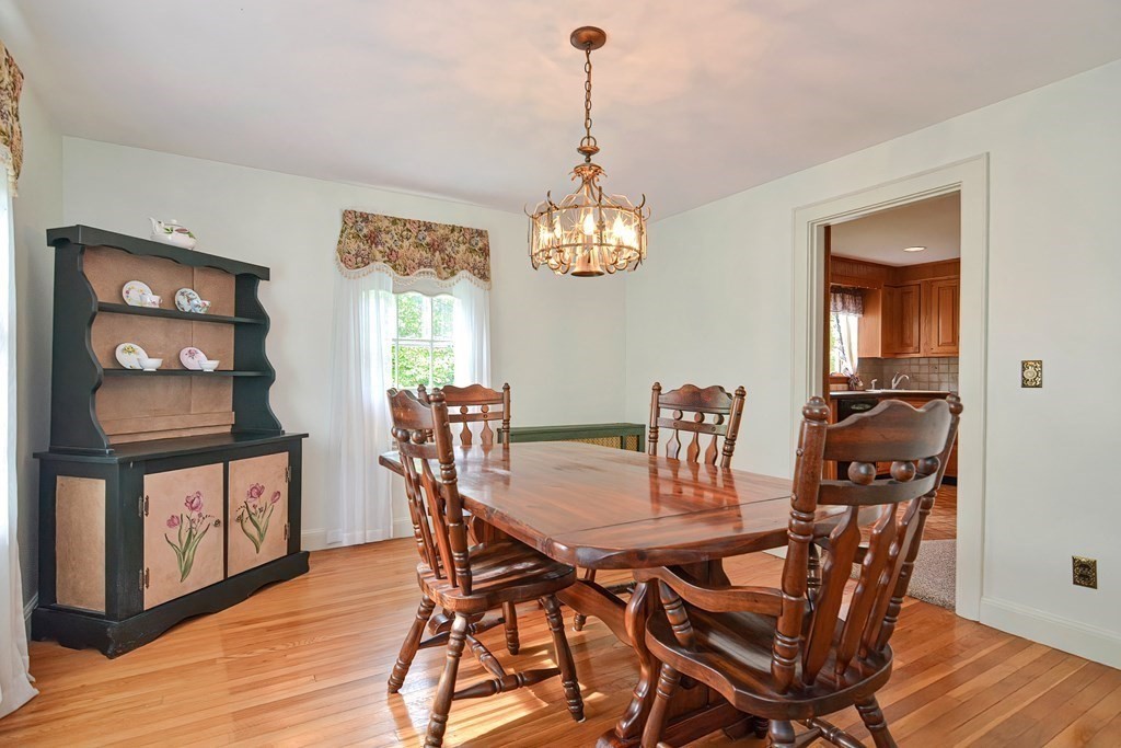 553 Winter Street Walpole, MA 02081 - Photo 18 of 42 a view of a dining room with furniture and chandelier