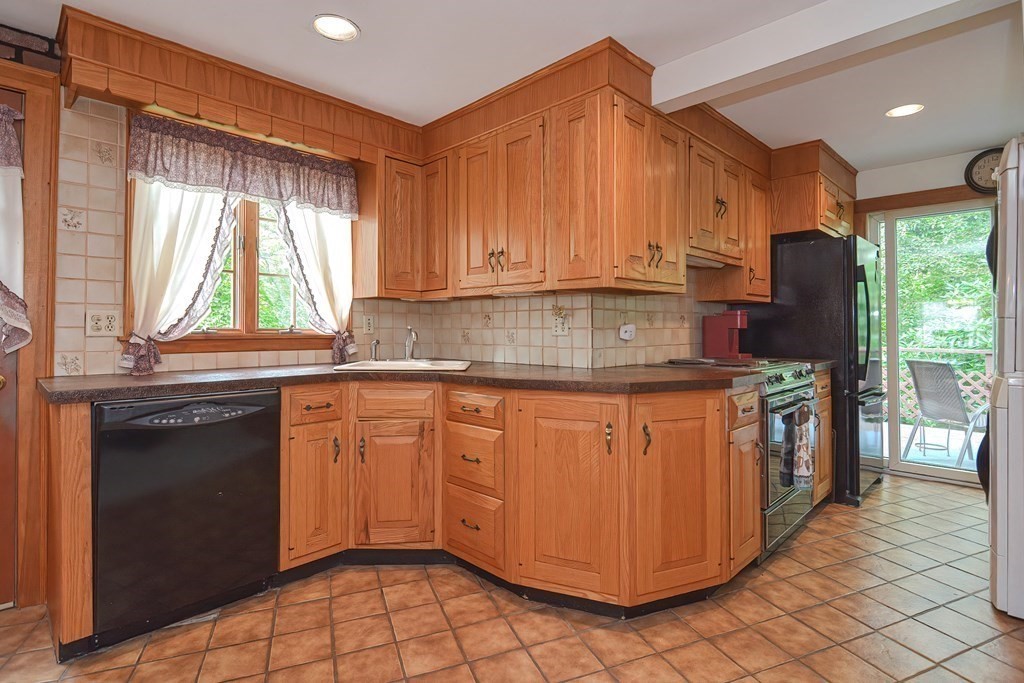 553 Winter Street Walpole, MA 02081 - Photo 21 of 42 a kitchen with stainless steel appliances granite countertop a stove a sink and a microwave