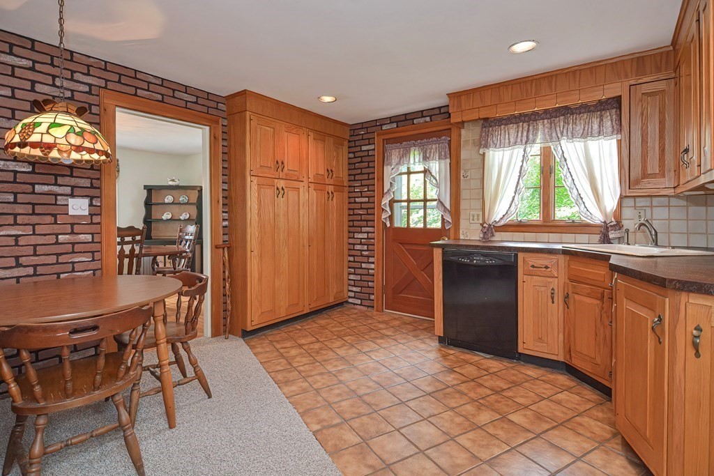 553 Winter Street Walpole, MA 02081 - Photo 22 of 42 a kitchen with stainless steel appliances granite countertop a stove a sink and a refrigerator