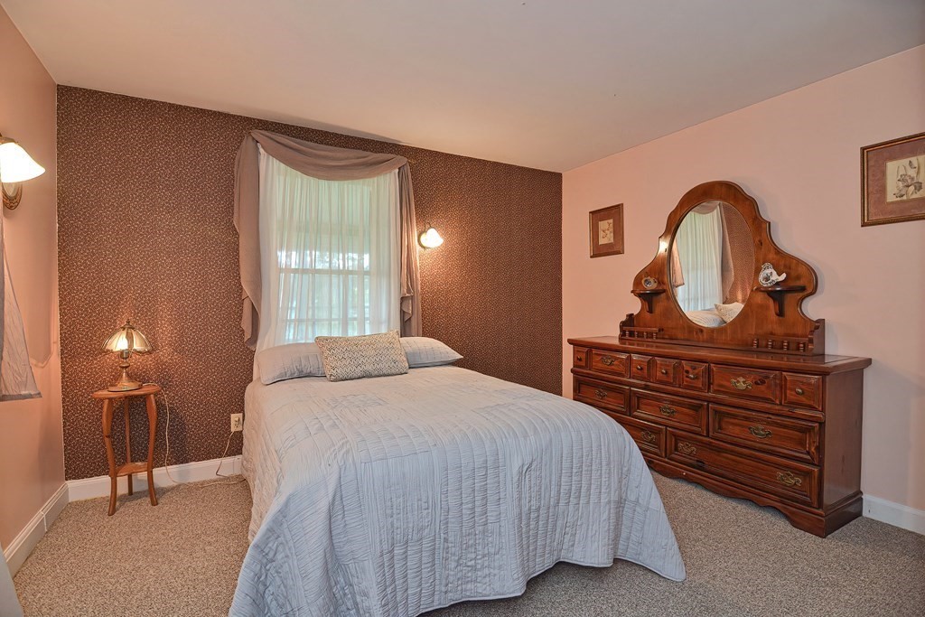 553 Winter Street Walpole, MA 02081 - Photo 25 of 42 a bedroom with a bed and a table