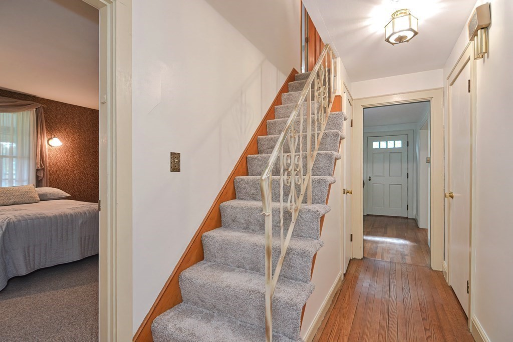 553 Winter Street Walpole, MA 02081 - Photo 27 of 42 a view of a hallway with wooden floor and stairs