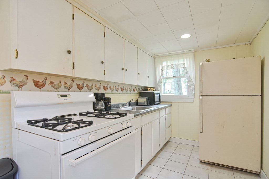 553 Winter Street Walpole, MA 02081 - Photo 39 of 42 a kitchen with a stove and a refrigerator