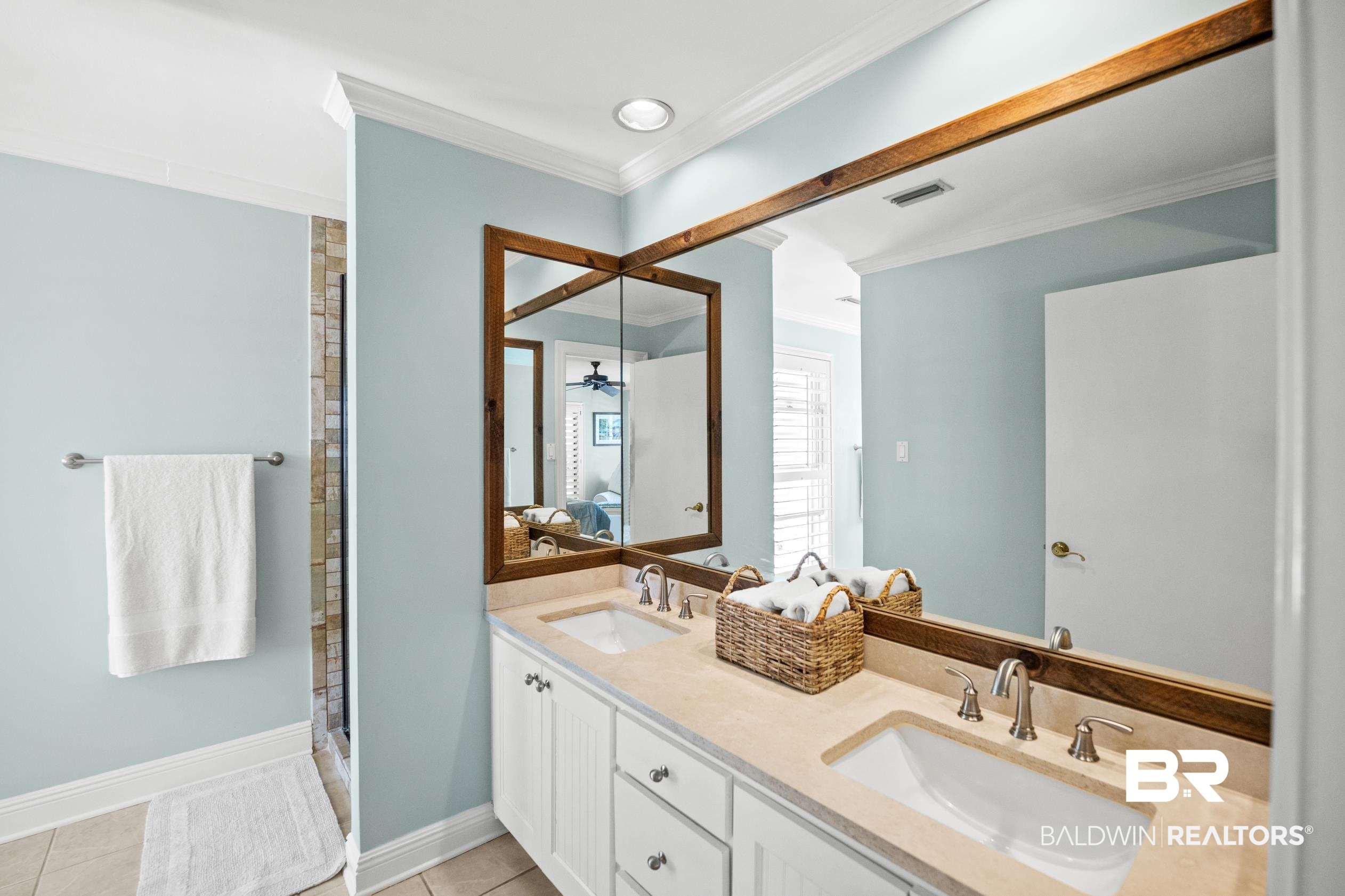 31304 River Road Orange Beach, AL 36561 - Photo 31 of 78 Bathroom featuring crown molding, a sink, tile patterned flooring, and connected bathroom