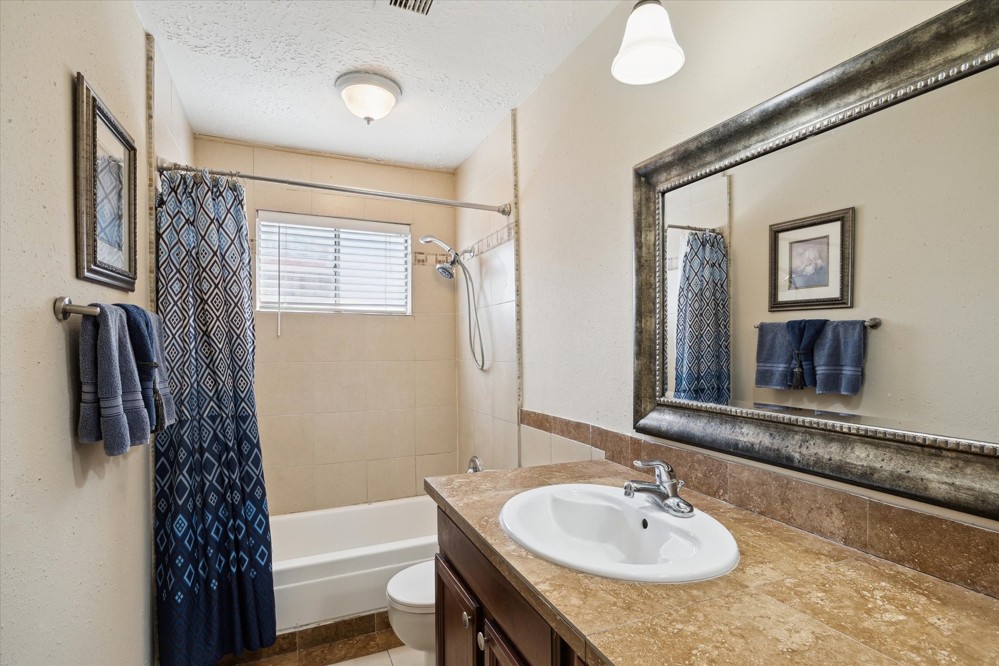 4226 Mossygate Drive Spring, TX 77373 - Photo 14 of 16 a bathroom with a sink a toilet and shower