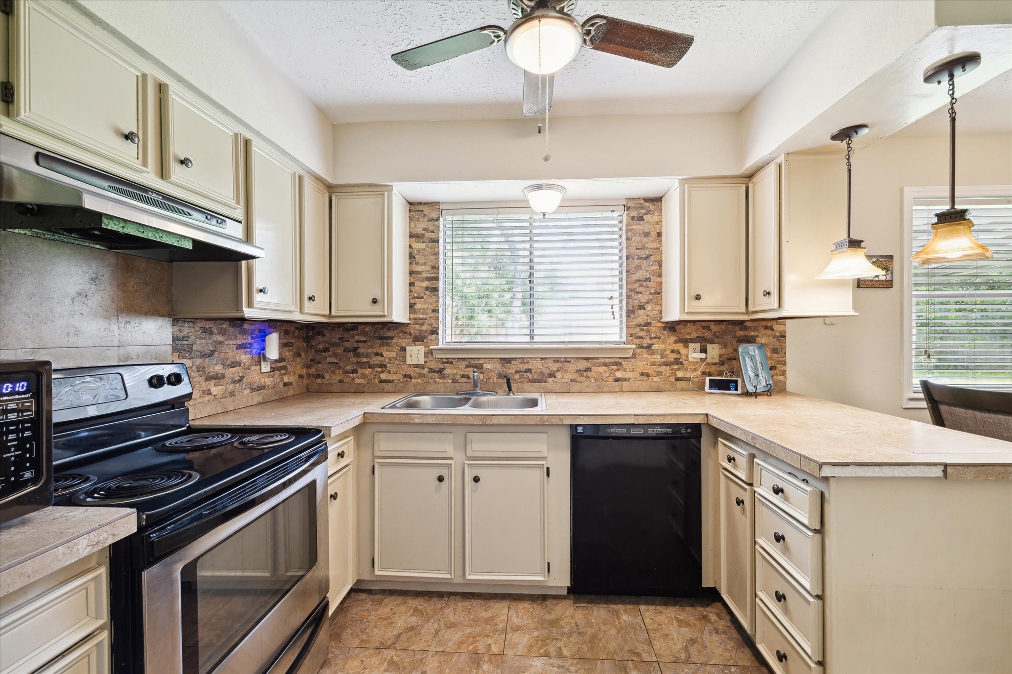 4226 Mossygate Drive Spring, TX 77373 - Photo 9 of 16 a kitchen with stainless steel appliances granite countertop a sink stove and cabinets