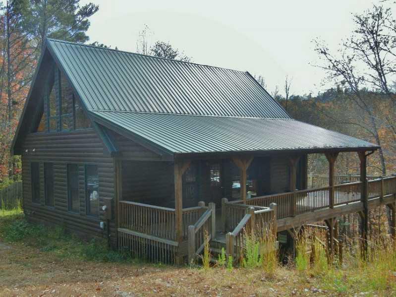 Exterior Front. Log clad siding with green metal roof!