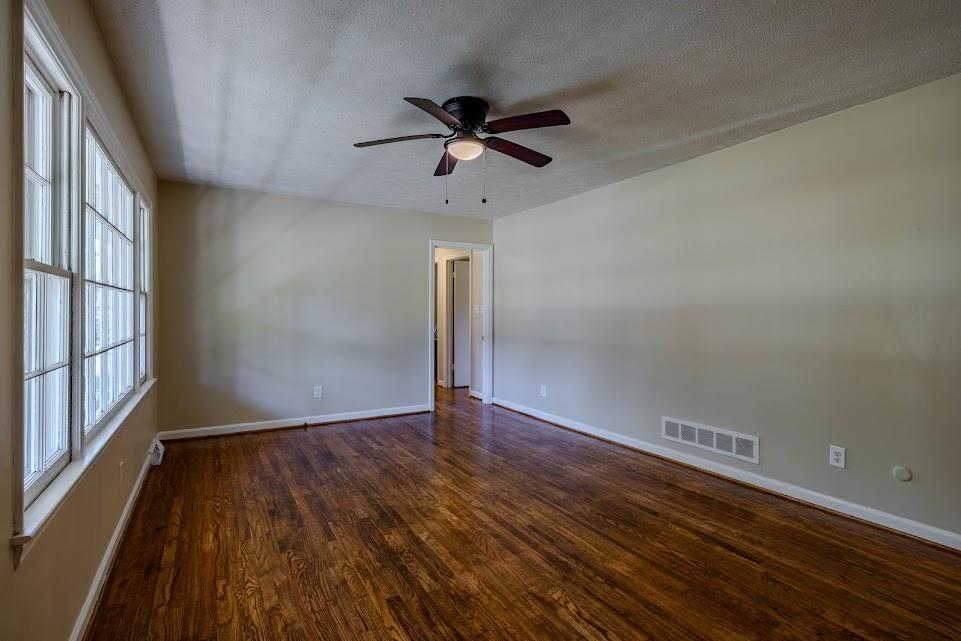 102 Beech Creek Drive Northwest Rome, GA 30165 - Photo 2 of 11 a view of empty room with wooden floor and fan
