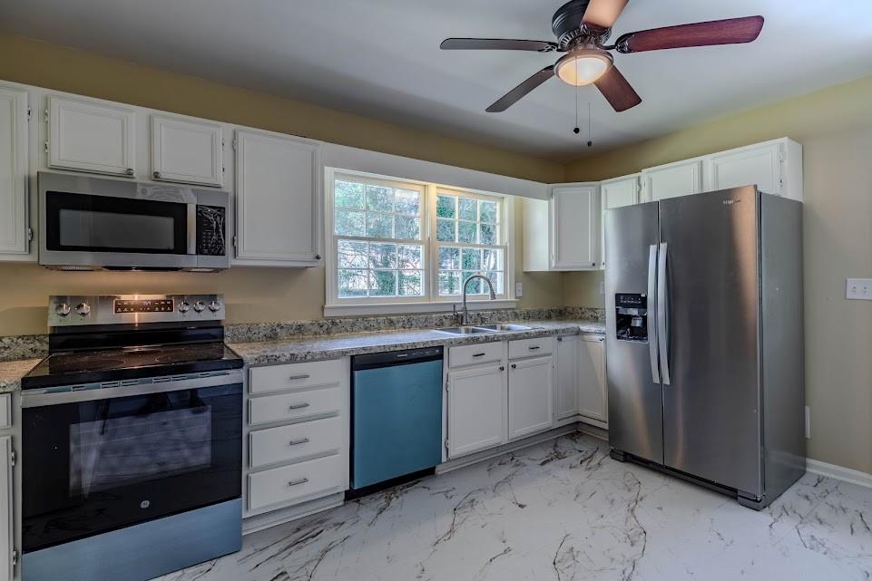 102 Beech Creek Drive Northwest Rome, GA 30165 - Photo 4 of 11 a kitchen with granite countertop a refrigerator stove and microwave