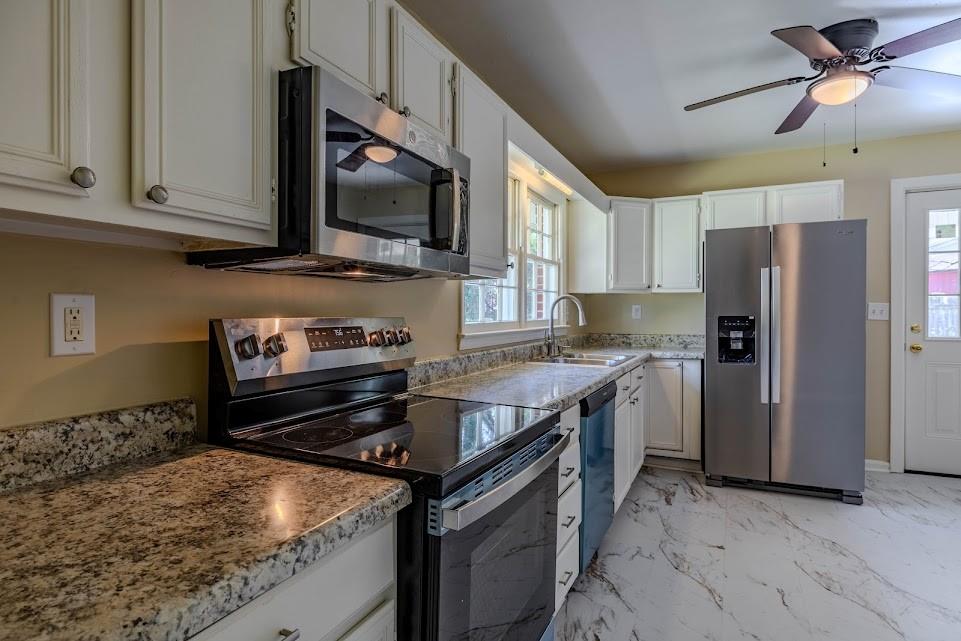 102 Beech Creek Drive Northwest Rome, GA 30165 - Photo 5 of 11 a kitchen with a stove microwave and refrigerator