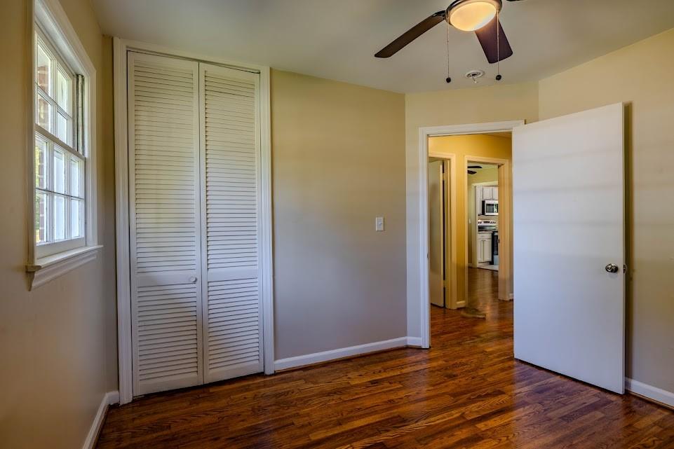 102 Beech Creek Drive Northwest Rome, GA 30165 - Photo 7 of 11 an empty room with wooden floor cabinet and windows