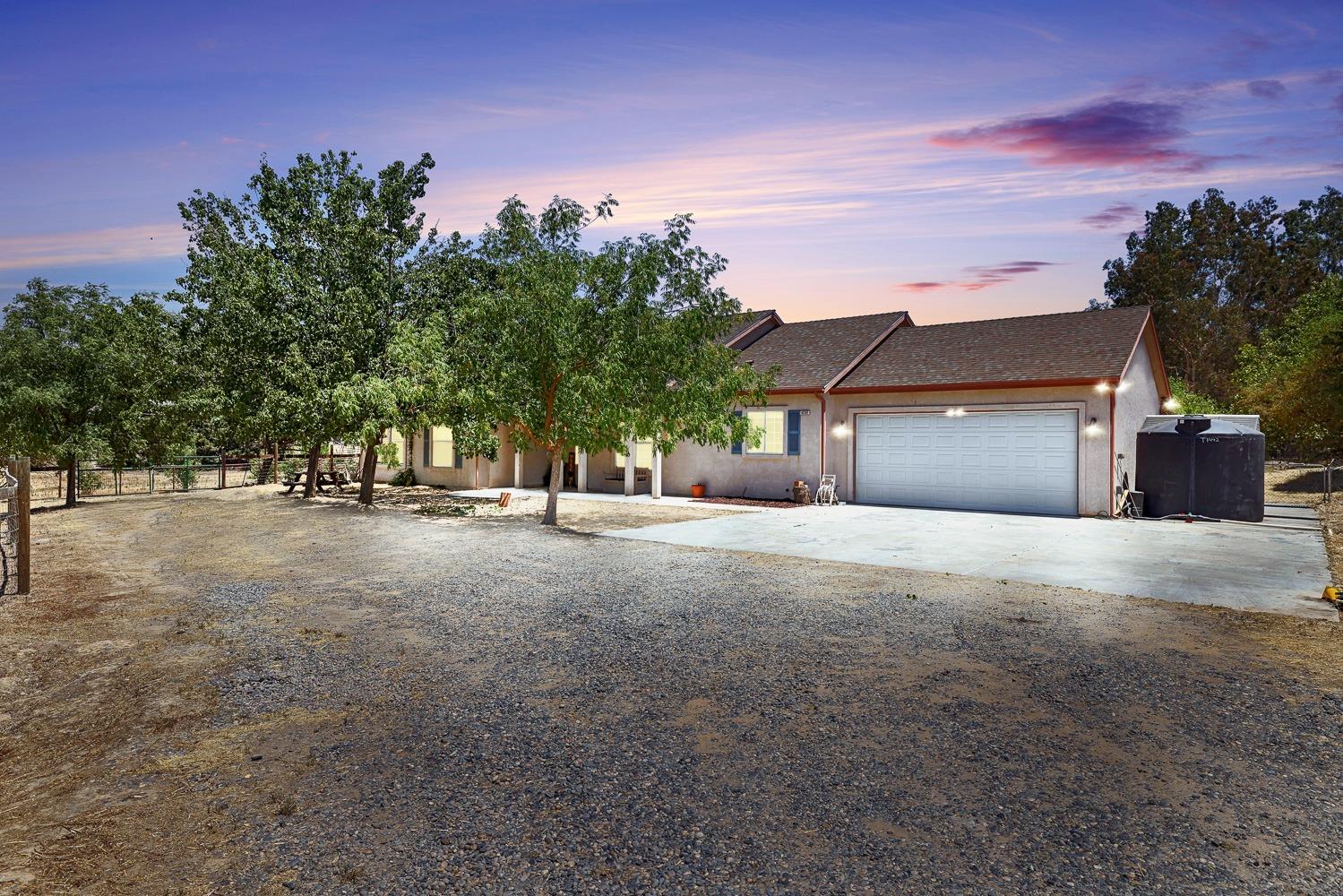 a view of a house with a tree and a yard