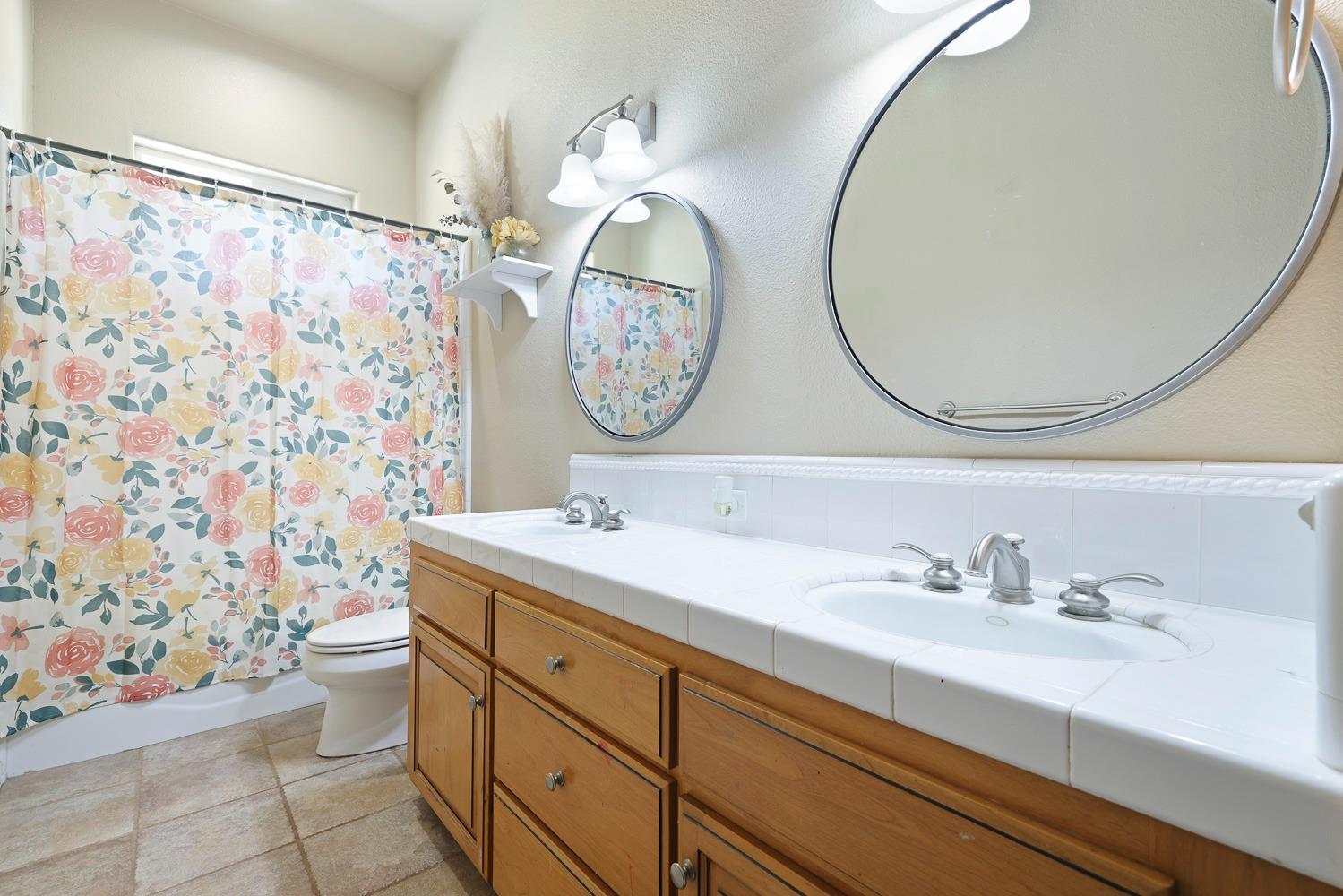 16787 Monreal Road Madera, CA 93636 - Photo 14 of 35 a bathroom with a sink a toilet and a mirror