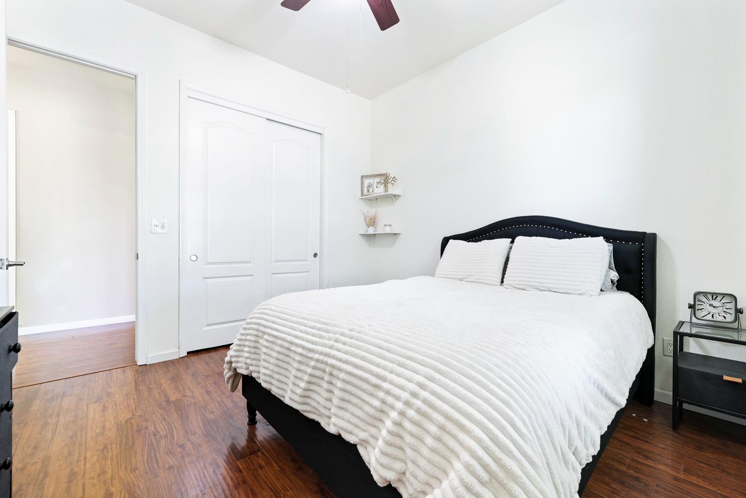 16787 Monreal Road Madera, CA 93636 - Photo 16 of 35 a bedroom with a bed and wooden floor