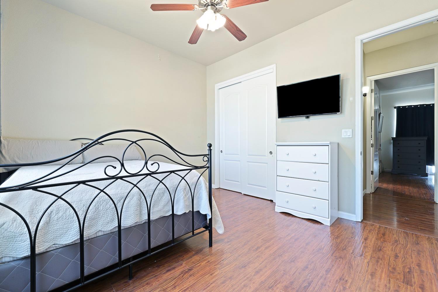 16787 Monreal Road Madera, CA 93636 - Photo 18 of 35 a bedroom with a bed and a flat screen tv