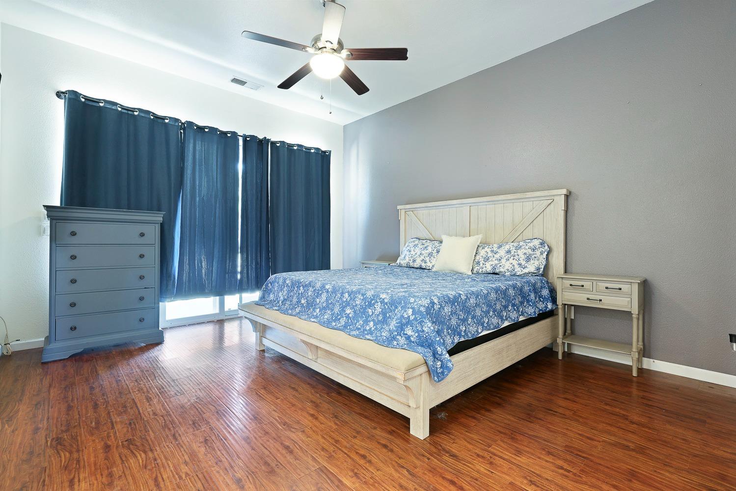 16787 Monreal Road Madera, CA 93636 - Photo 20 of 35 a bedroom with a bed and wooden floor