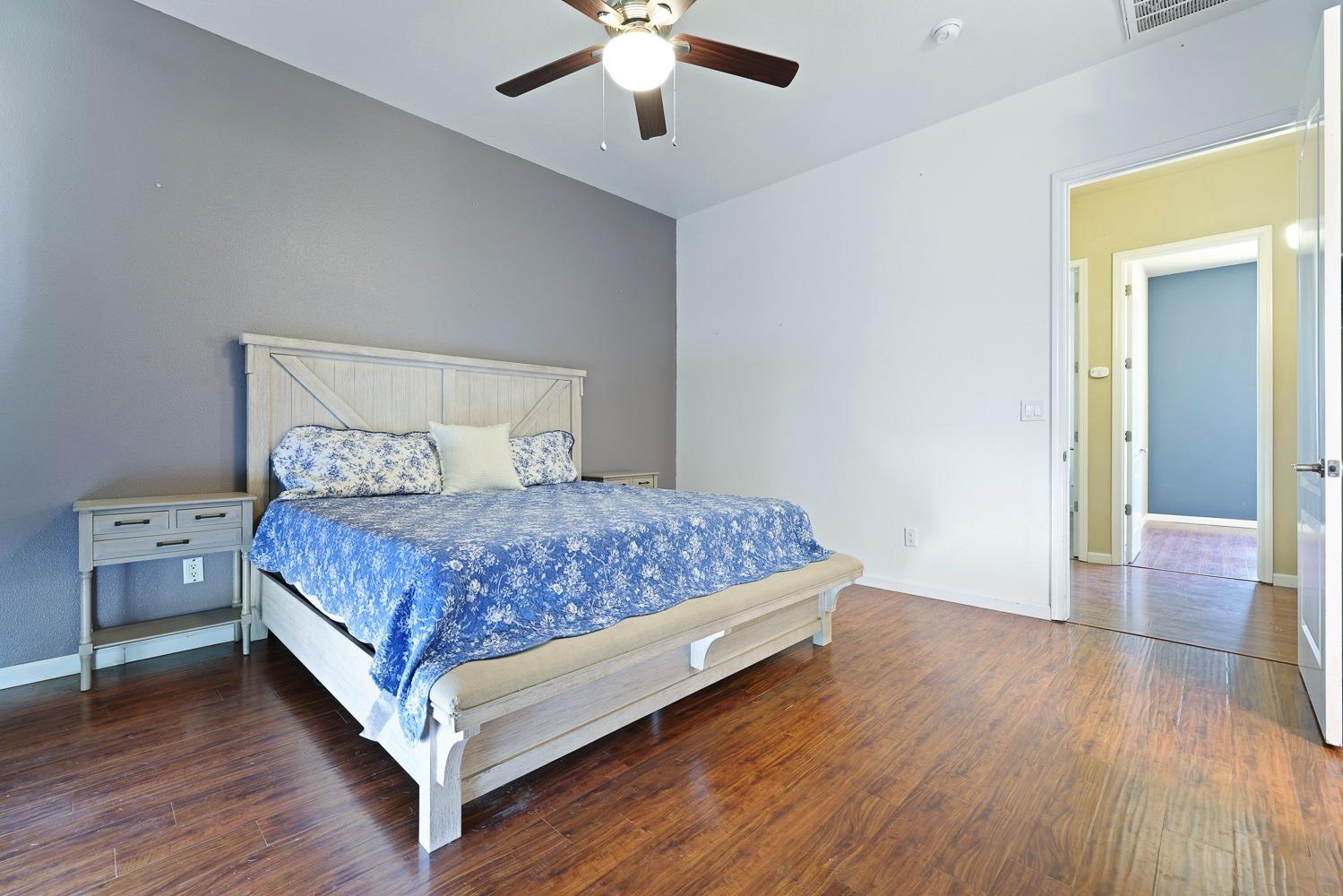 16787 Monreal Road Madera, CA 93636 - Photo 21 of 35 a bedroom with a bed and a chandelier