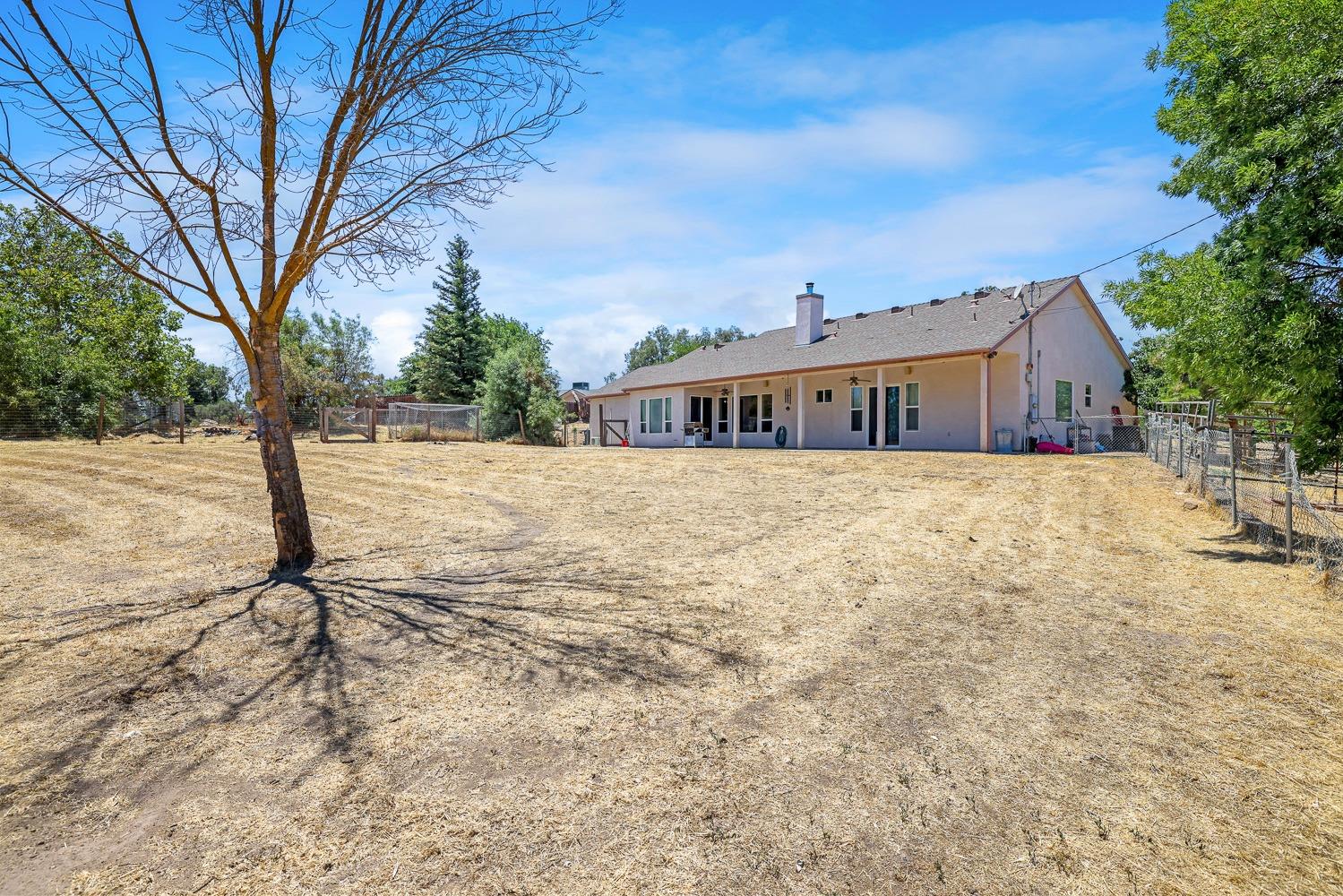 16787 Monreal Road Madera, CA 93636 - Photo 24 of 35 a view of a house with a yard